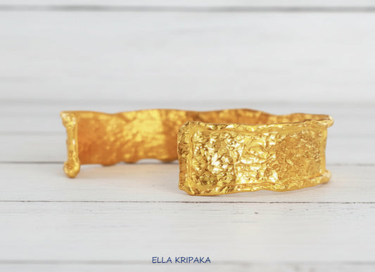 Hammered organic 24k 9999 gold uneven bracelet cuff on a wooden background, branding artist-jeweler name 'Ella Kripaka'