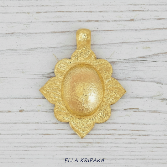 24k gold hammered textured dome pendant with Byzantune ornament is on white rustic wooden surface, with artist-jeweler 'Ella Kripaka' branding