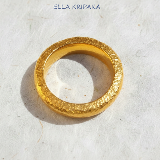 Hammered 24k 9999 Gold thick ring Ancient Rome style with a textured surface on a white paper background, branded 'Ella Kripaka'