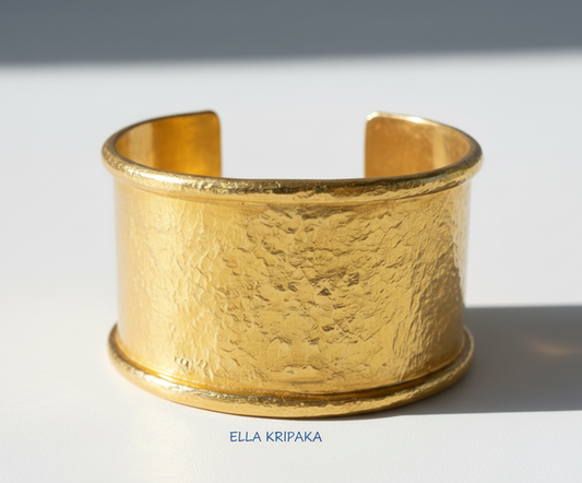 Hammered 24k 9999 gold bracelet large cuff Ancient Rome style with thick borders on a white background, branding artist-jeweler name 'Ella Kripaka'