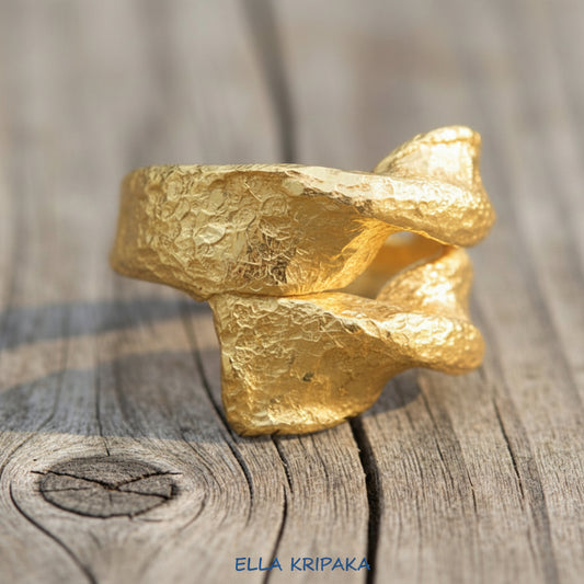 Twisted hammered 24k 9999 Gold ring signet with textured gold on a wooden surface, artist-jeweler's name 'Ella Kripaka' is written on picture