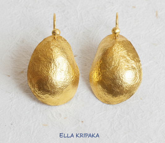 organic 24k 9999 gold hammered uneven convex oval earrings with forged gold textures on a white paper surface, artist's name 'Ella Kripaka'