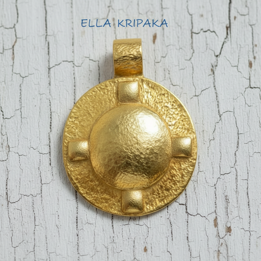 Hammered 24k Gold dome oval pendant with 4 convex squares on a white rustic wooden background with 'Ella Kripaka' branding