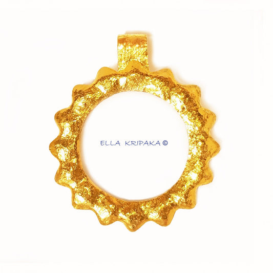 24k 9999 gold hammered Sun pendant on a white surface, branded 'Ella Kripaka'