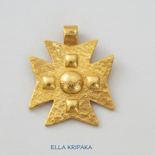 24k gold Byzantine cross pendant textured hammered with convex pattern on white paper background, with 'Ella Kripaka' branding