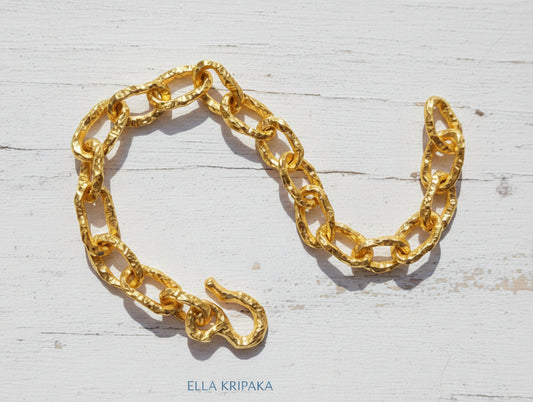 Hammered 24k 9999 gold organic bracelet chain with hammered uneven textures and a thick hook clasp, artist name 'Ella Kripaka'