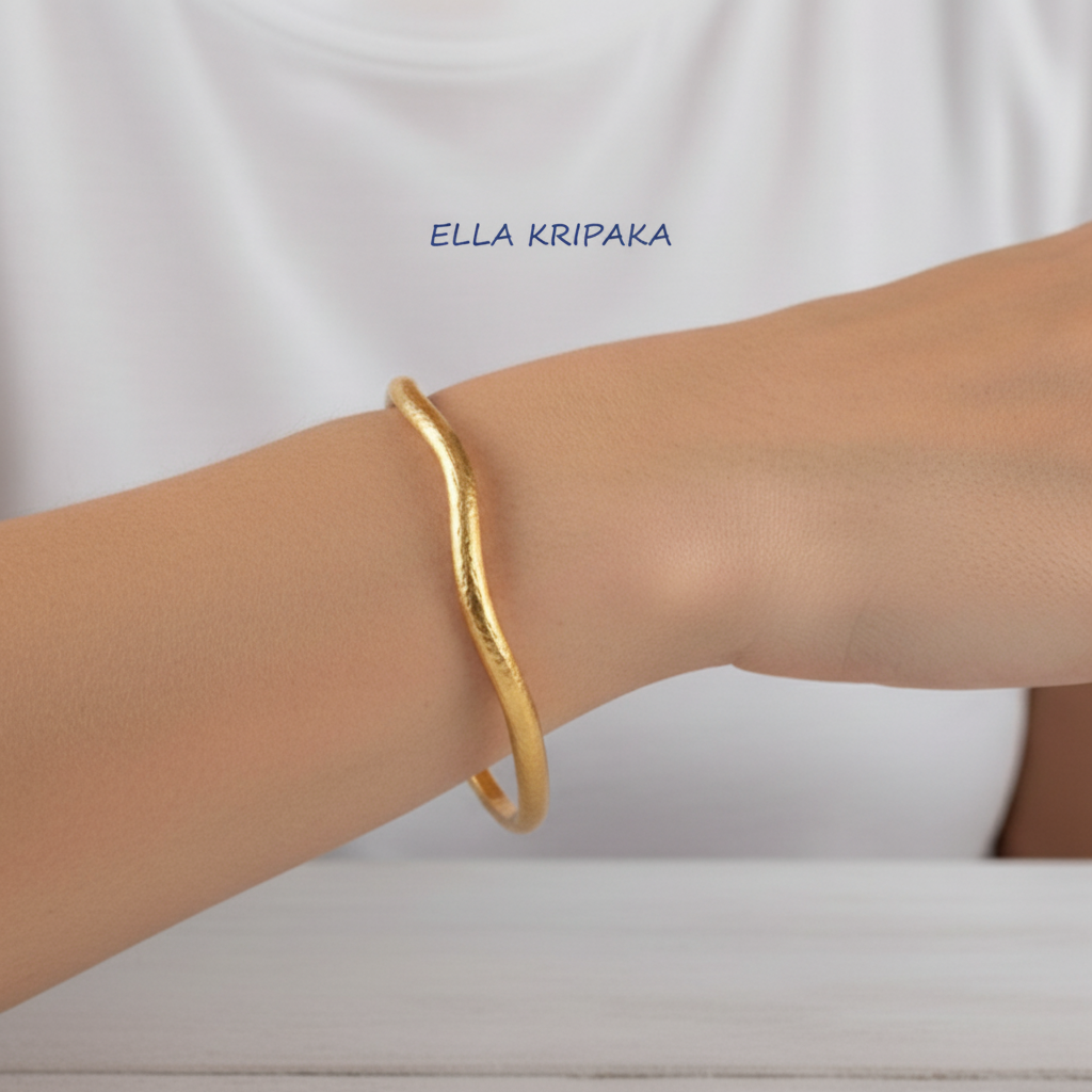 Organic 24k gold hammered textured bangle thick bracelet with uneven shape on woman's wrist, artist-jeweler 'Ella Kripaka'