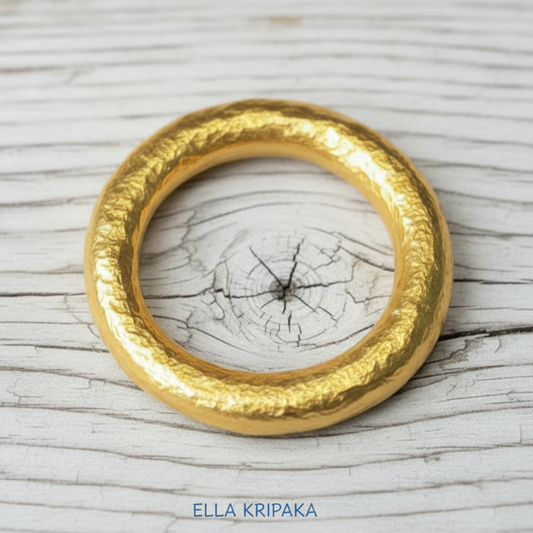 Hammered 24k 9999 Gold ring thick Ancient Rome style on old white wooden surface, artist-jeweler's name 'Ella Kripaka' branding