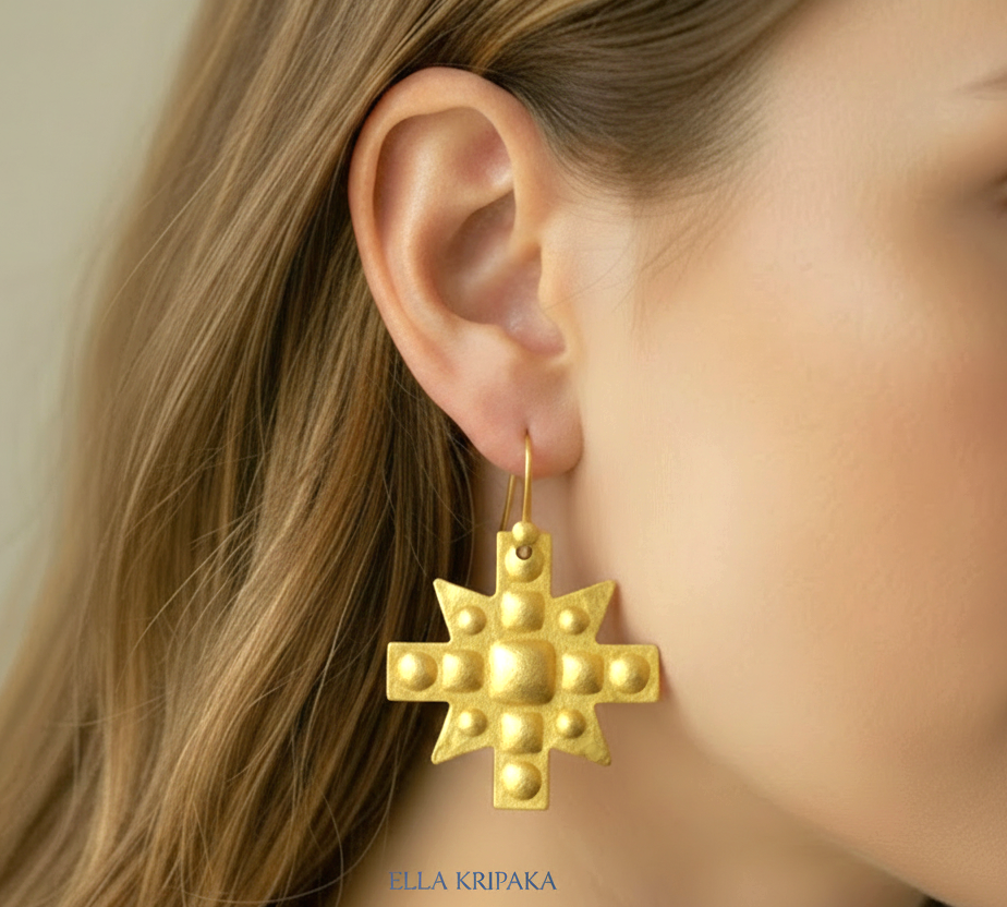 Hammered 24k 9999 Gold Byzantine cross earrings worn by a woman on a neutral background with 'Ella Kripaka' branding