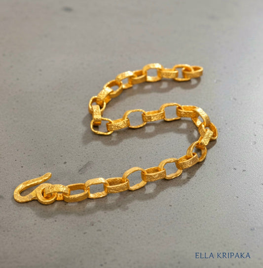 Hammered 24k 9999 gold chain thick bracelet with thick hook clasp Ancient Rome style on a grey background, artist-jeweler name 'Ella Kripaka' branding
