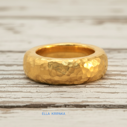 Hammered 24k Gold 9999 gold Ancient Rome thick ring band with textured gold on a white rustic wooden background, branded 'Ella Kripaka'