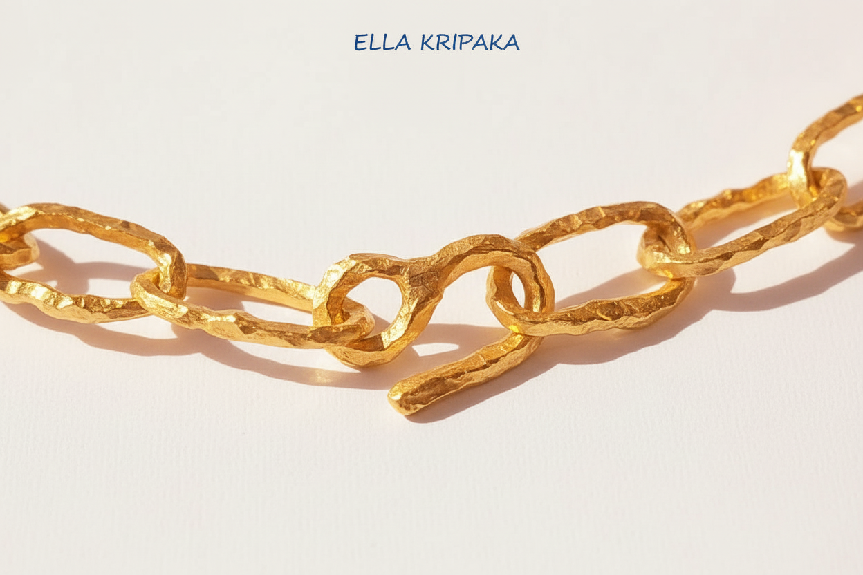 Organic 24k Gold hammered uneven textured chain with thick uneven hook clasp on a white craft paper surface, with artist 'Ella Kripaka' branding