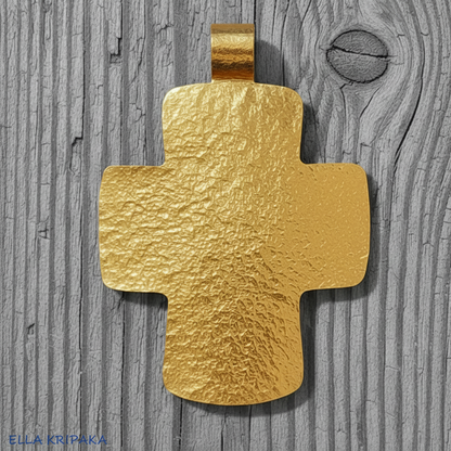 Hammered 24k gold textured cross pendant on a grey rustic wooden surface, artist-jeweler 'Ella Kripaka' branding