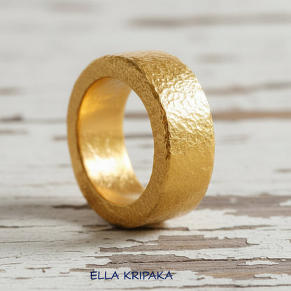 Hammered 24k Gold 9999 gold thick ring band Ancient Rome style with textured gold on old white wooden background, branded 'Ella Kripaka'