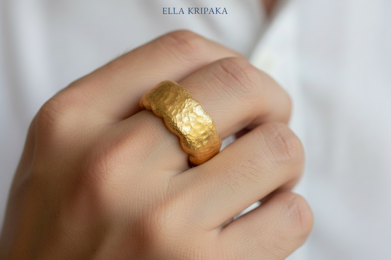 Organic hammered 24k gold 9999 Gold textured wavy thick ring on a man's finger and a neutral background with 'ELLA KRIPAKA' branding