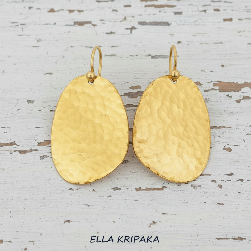 Hammered 24k Gold textured earrings uneven shape ovals on a white rustic wooden background, and with 'Ella Kripaka' branding