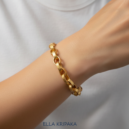 Hammered 24k 9999 gold chain thick bracelet Ancient Rome style worn by a model on hand and on a grey background, artist-jeweler name 'Ella Kripaka' branding