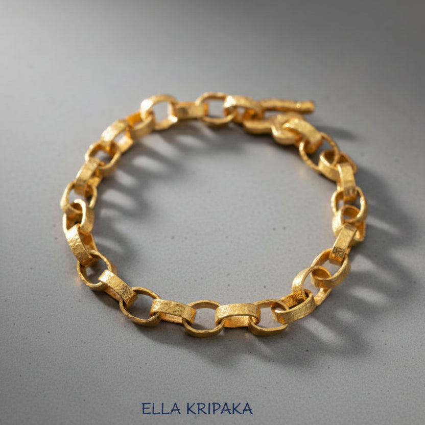 Hammered 24k 9999 gold chain thick bracelet with thick hook clasp Ancient Rome style on a grey background, artist-jeweler name 'Ella Kripaka' branding