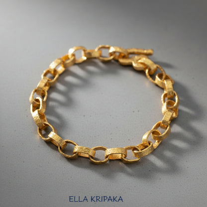 Hammered 24k 9999 gold chain thick bracelet with thick hook clasp Ancient Rome style on a grey background, artist-jeweler name 'Ella Kripaka' branding