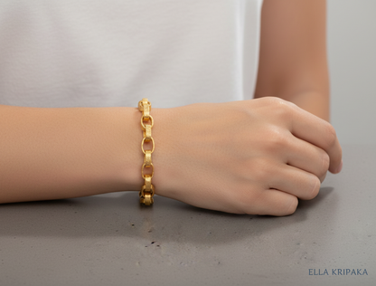 Hammered 24k 9999 gold chain thick bracelet Ancient Rome style worn by a woman on wrist and on a grey background, artist-jeweler name 'Ella Kripaka' branding