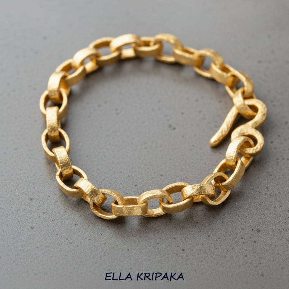 Hammered 24k 9999 gold chain thick bracelet with thick hook clasp Ancient Rome style on a grey background, artist-jeweler name 'Ella Kripaka' branding