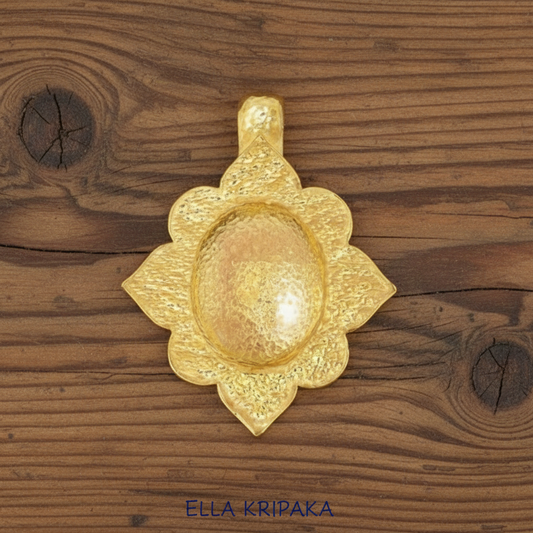 24k 9999 gold hammered Byzantine dome pendant with shiny forged gold textures is on a old rustic wooden surface, artist's name 'Ella Kripaka'