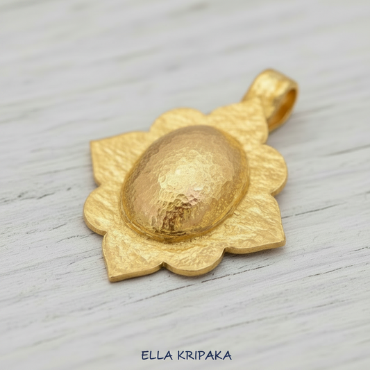 24k gold hammered textured dome pendant with Byzantune ornament is on white rustic wooden surface, with artist-jeweler 'Ella Kripaka' branding