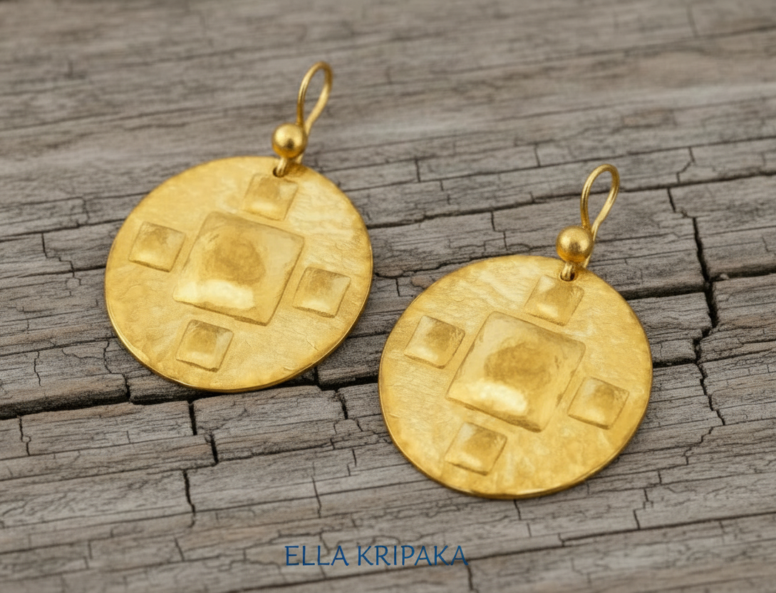 Hammered 24k 9999 Gold Byzantine earrings on a old wooden background with 'Ella Kripaka' branding