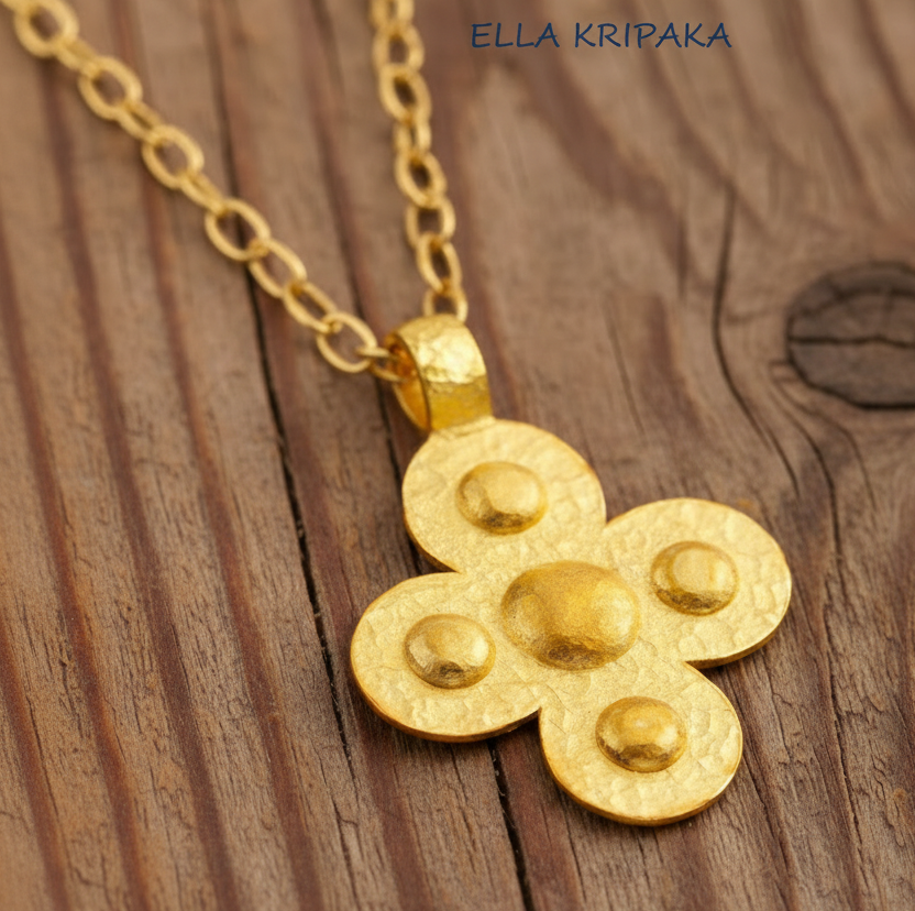 24k 9999 gold hammered Byzantine cross pendant on chain and with forged gold textures is on a old wooden surface, artist's name 'Ella Kripaka'