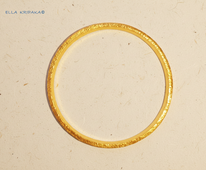 Hammered 24k 9999 gold bangle thick bracelet Ancient Rome style on a neutral background, branding artist-jeweler name 'Ella Kripaka'