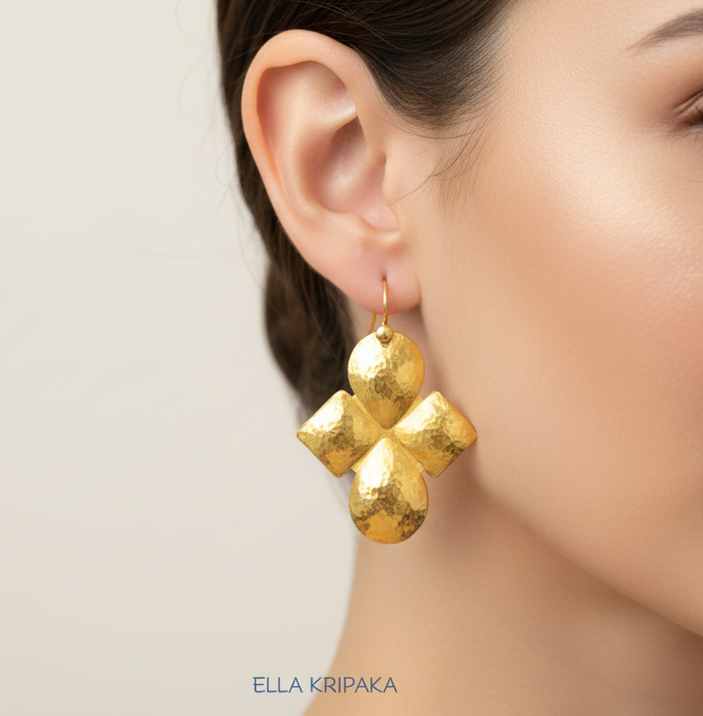 Hammered Byzantine Cross convex 24k 9999 gold earrings worn by a model with a neutral background, featuring the brand 'Ella Kripaka'
