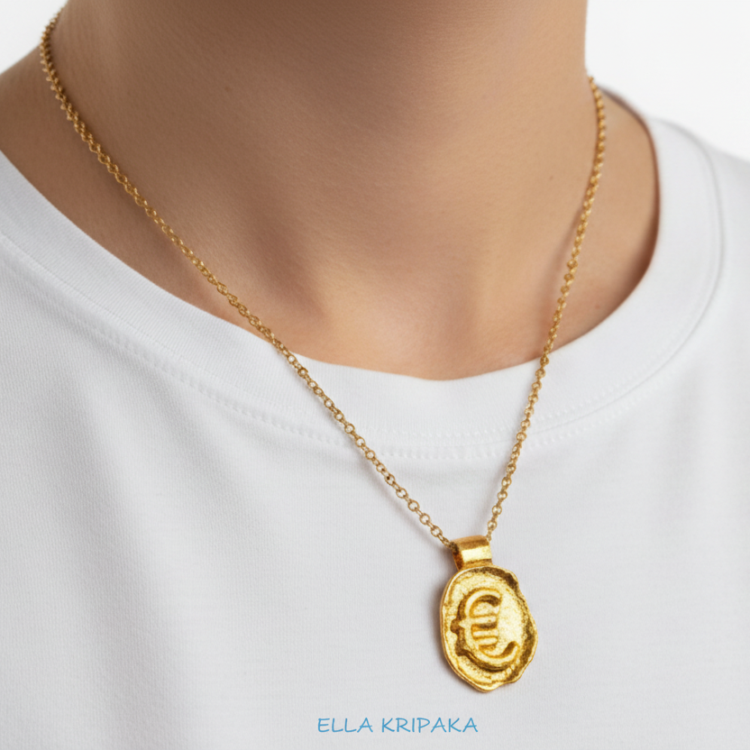 Hammered 24k 9999 Gold organic uneven pendant with Euro Sign is with chain wearing on  woman in white t-shirt, artist's name 'Ella Kripaka' 