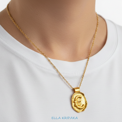 Hammered 24k 9999 Gold organic uneven pendant with Euro Sign is with chain wearing on  woman in white t-shirt, artist's name 'Ella Kripaka' 