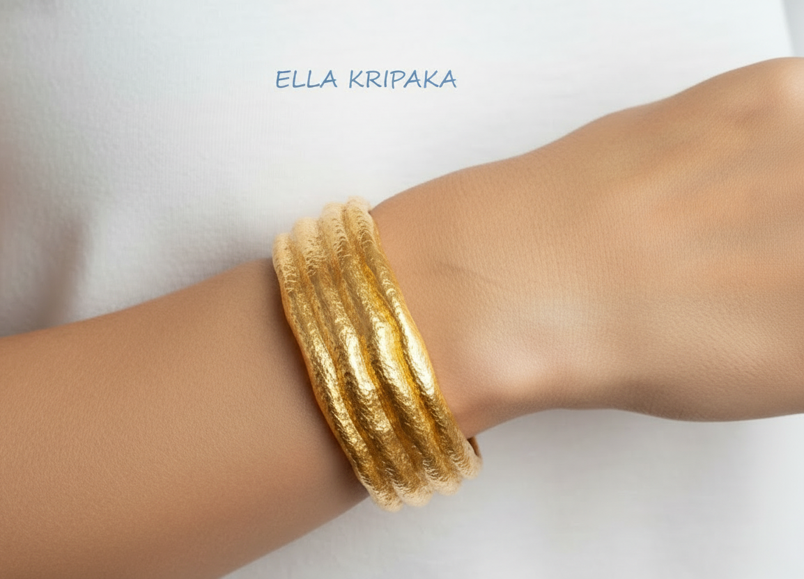 Organic hammered 24k 9999 Gold uneven cuff bracelet on a woman's wrist on white background, with artist's name 'Ella Kripaka' branding.