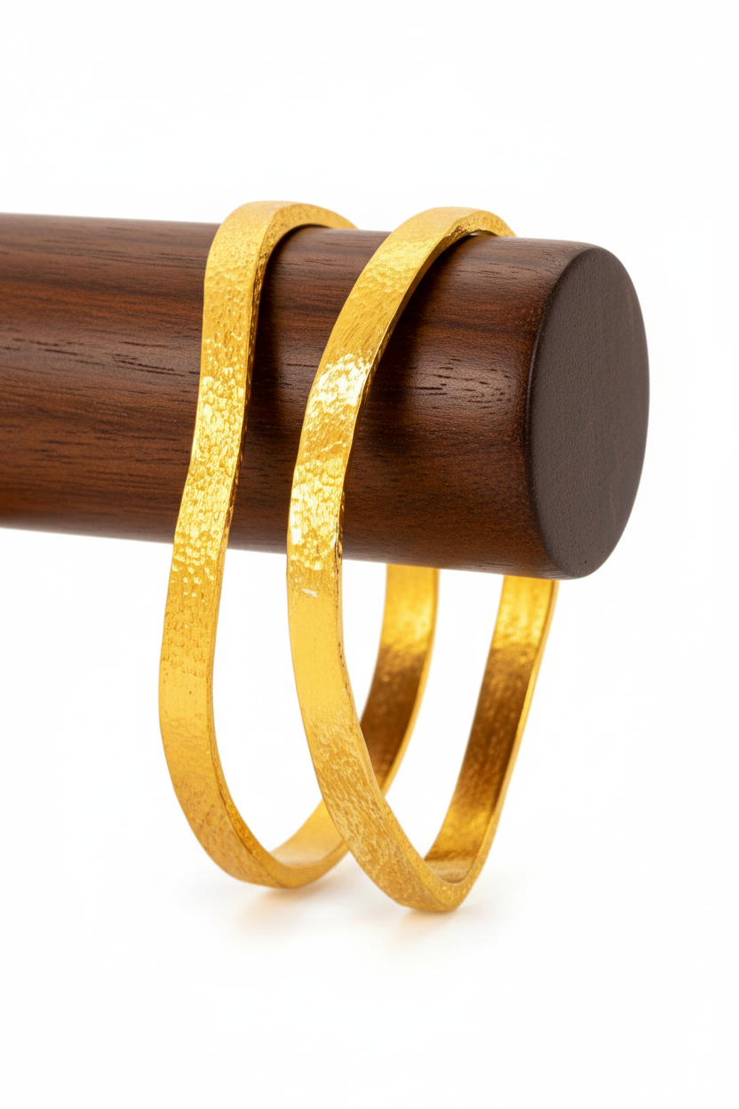 Organic 24k gold 9999 gold hammered two unevenbangles thick bracelets with uneven forms on wooden stand, artist-jeweler 'Ella Kripaka'