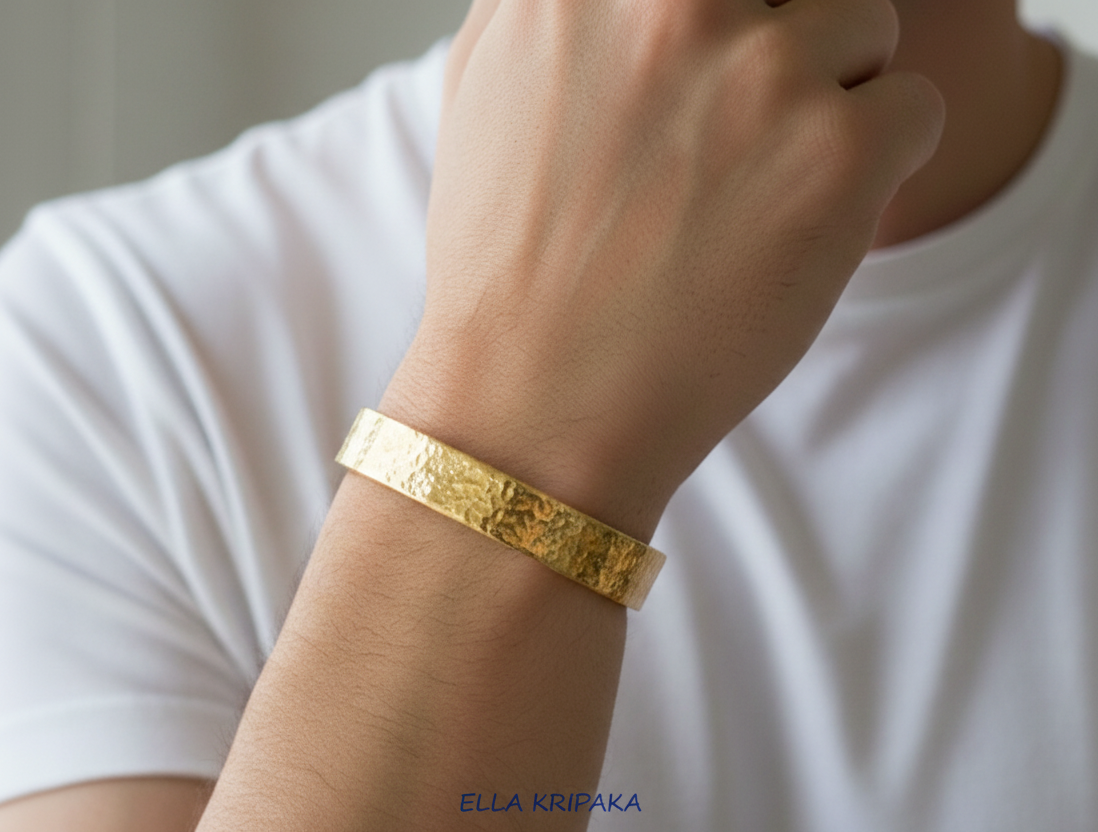 24k 9999 Gold hammered bracelet worn on a man's wrist with a white t-shirt background, artist name 'Ella Kripaka'