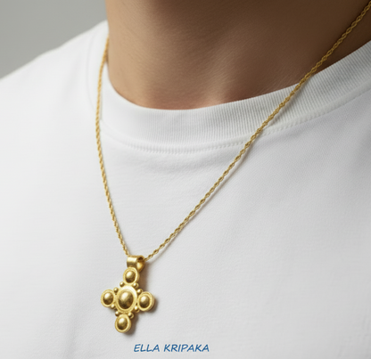 24k 9999 gold hammered Byzantine cross pendant with shiny forged gold textures is with chain wearing on model in white t-short, artist's name 'Ella Kripaka'
