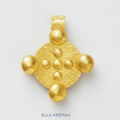 24k 9999 gold hammered Byzantine disk pendant with forged gold textures is on a white surface, artist's name 'Ella Kripaka'