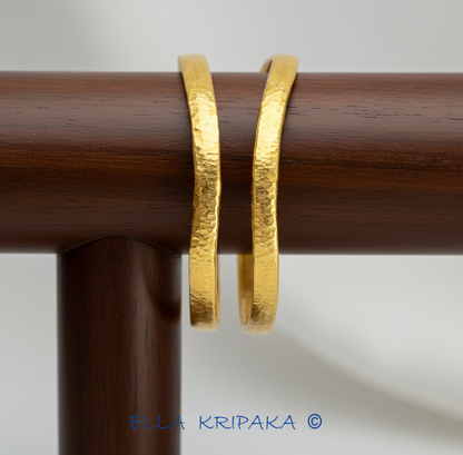 Organic 24k gold 9999 gold hammered two uneven bangles thick bracelets with uneven shape on wooden stand, artist-jeweler 'Ella Kripaka'