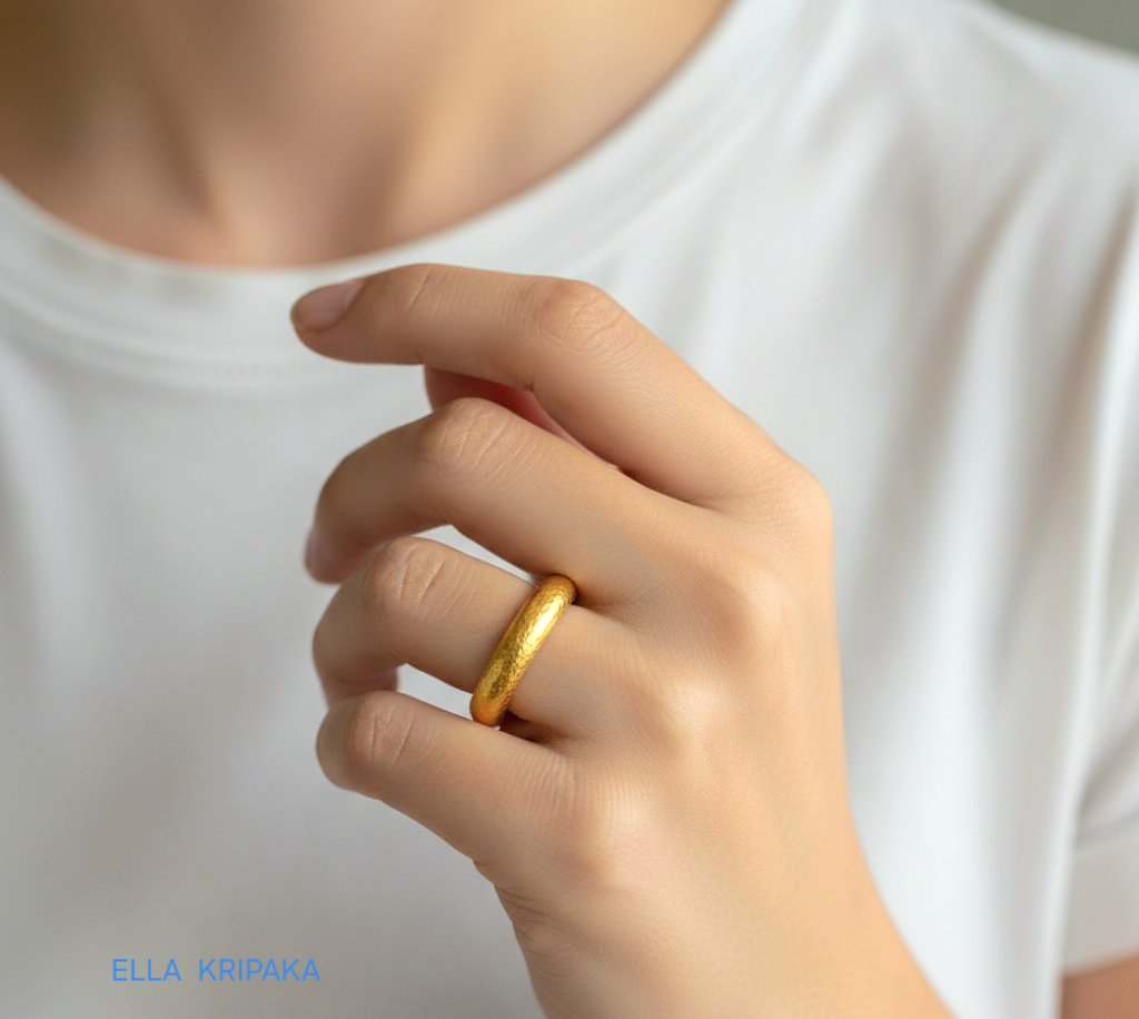Hammered 24k 9999 Gold ring thick band Ancient Rome style and with forged textured gold worn on model's finger and on a white plain background, artist-jeweler's name 'Ella Kripaka' branding