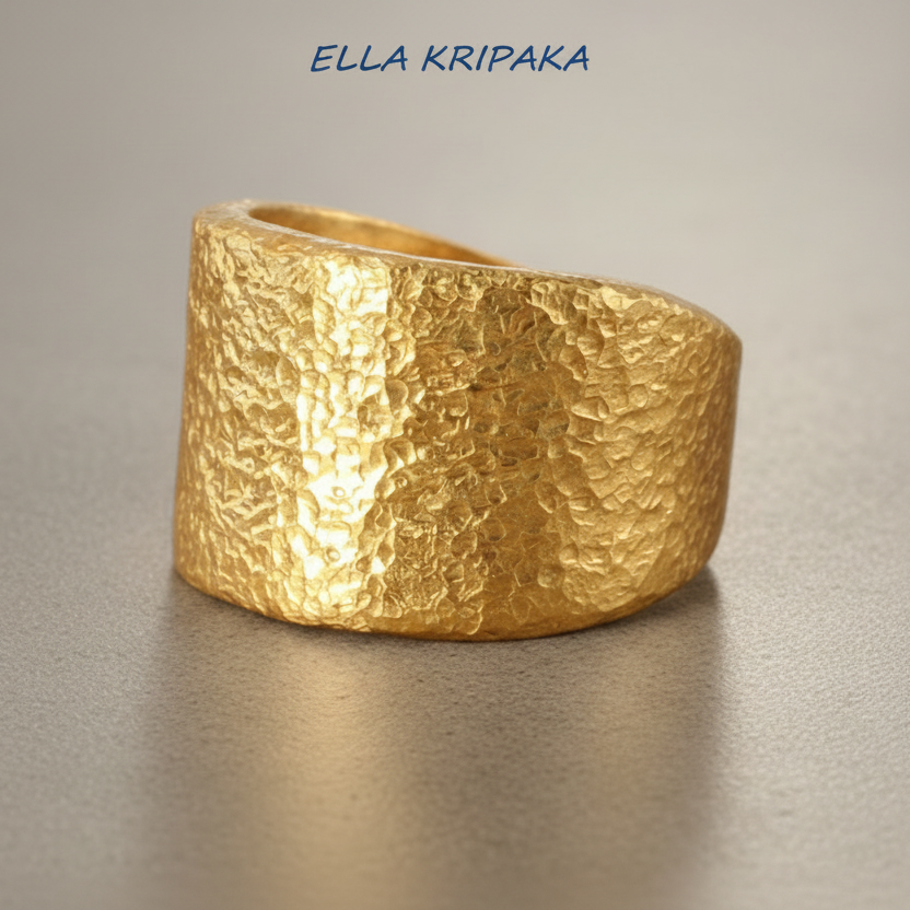 Hammered 24k Gold 9999 gold Ancient Rome  thick ring large signet with textured gold on a grey concrete background, branded 'Ella Kripaka'
