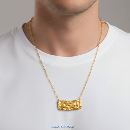 Hammered 24k 9999 Gold organic uneven wavy rectangular pendant with chain wearing on man in a white t-shirt, artist's name 'Ella Kripaka' 