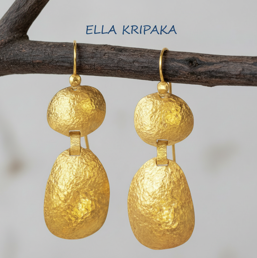 Organic 24k 9999 gold hammered uneven dome earrings with forged gold textures hanging on a branch, artist's name 'Ella Kripaka'