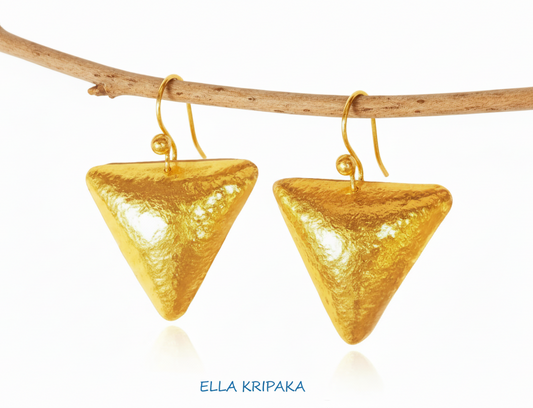 24k 9999 gold hammered triangle dome earrings with forged gold textures are hinging on a branch, artist's name 'Ella Kripaka'