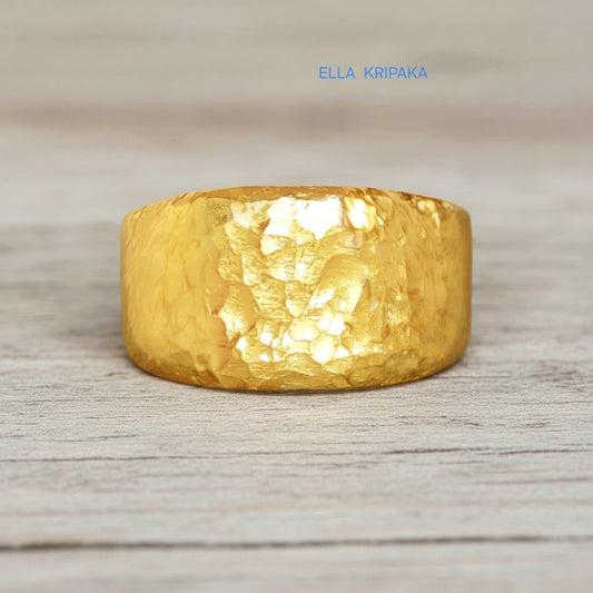 Hammered 24k 9999 Gold ring thick signet Ancient Rome style and with forged textured gold on a white old wooden surface, artist-jeweler's name 'Ella Kripaka' branding
