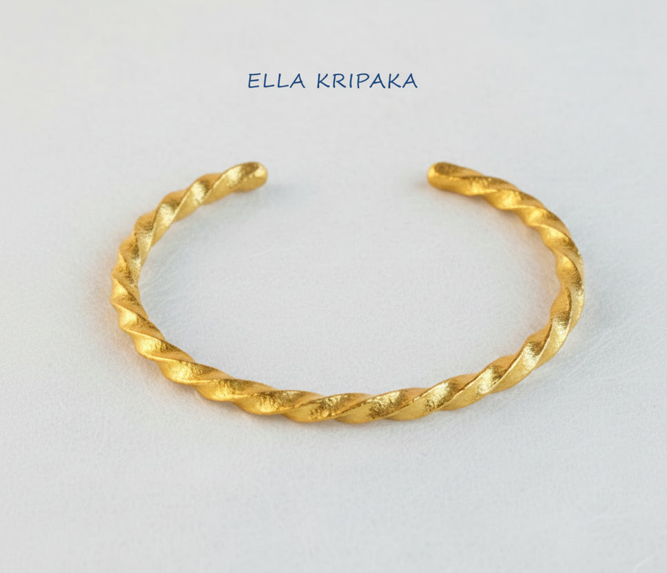 Viking twisted 24k 9999 gold thick cuff bracelet on a white background with 'Ella Kripaka' branding