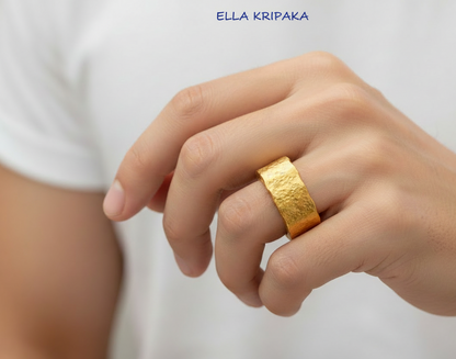 Organic hammered 24k 9999 Gold wavy ring band with thick wavy edges and with forged gold textures is worn by a man on finger and on white surface, artist-jeweler's name 'Ella Kripaka' branding