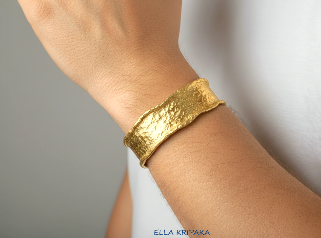 Organic hammered 24k gold bracelet cuff wifh folded uneven edges on a man's wrist and on neutral background, branding artist 'Ella Kripaka'