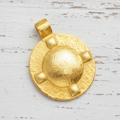 Hammered 24k Gold dome oval pendant with 4 convex squares on a white rustic wooden background with 'Ella Kripaka' branding