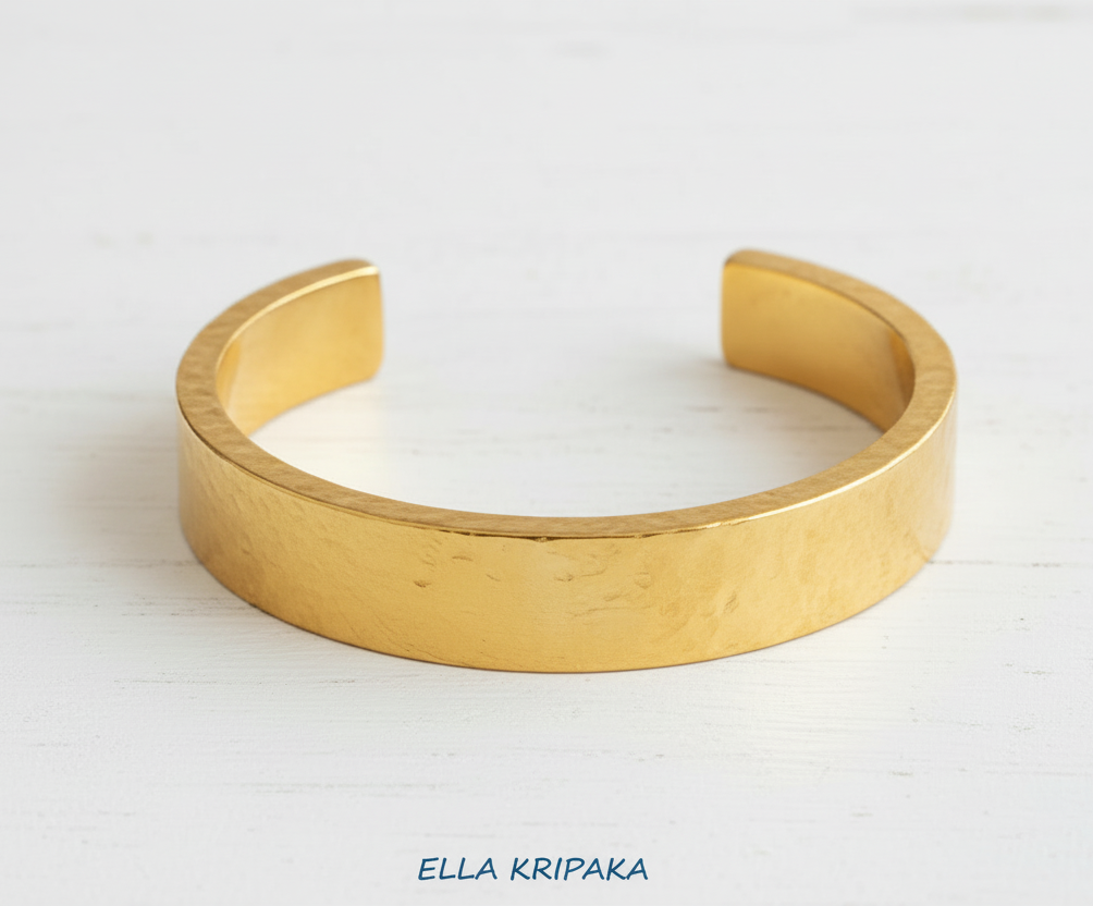 Hammered 24k 9999 Gold thick cuff bracelet Ancient Rome style on a neutral background with 'Ella Kripaka' branding